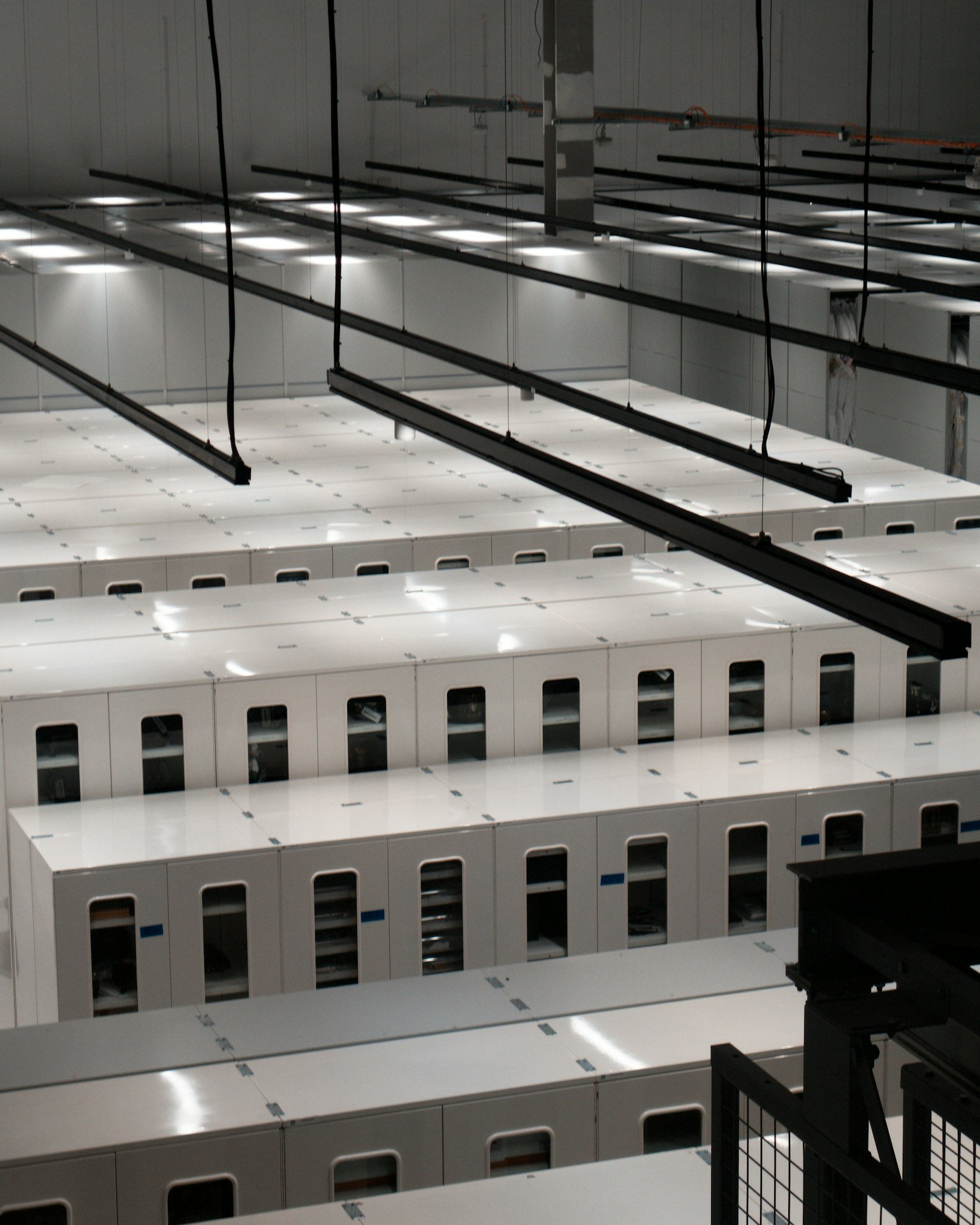 Rows of server cabinets in a modern data centre, representing the infrastructure behind a hospital group AI strategy