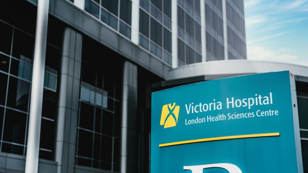 The exterior of a modern hospital building with glass facade and entrance signage