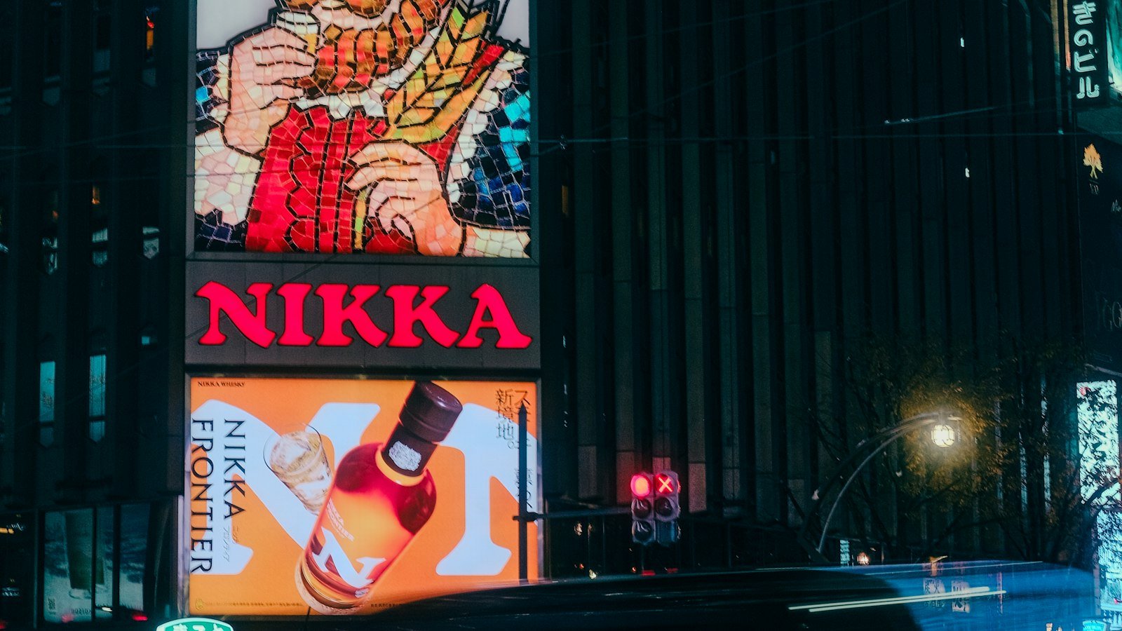Illuminated advertising in a city at night, representing ChatGPT ads