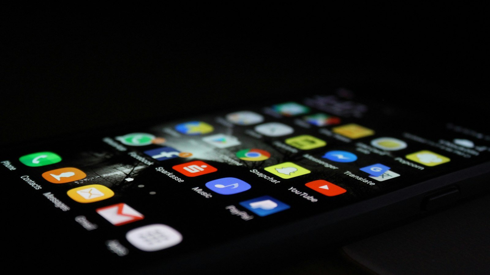 Smartphone on a desk showing a stack of app notifications