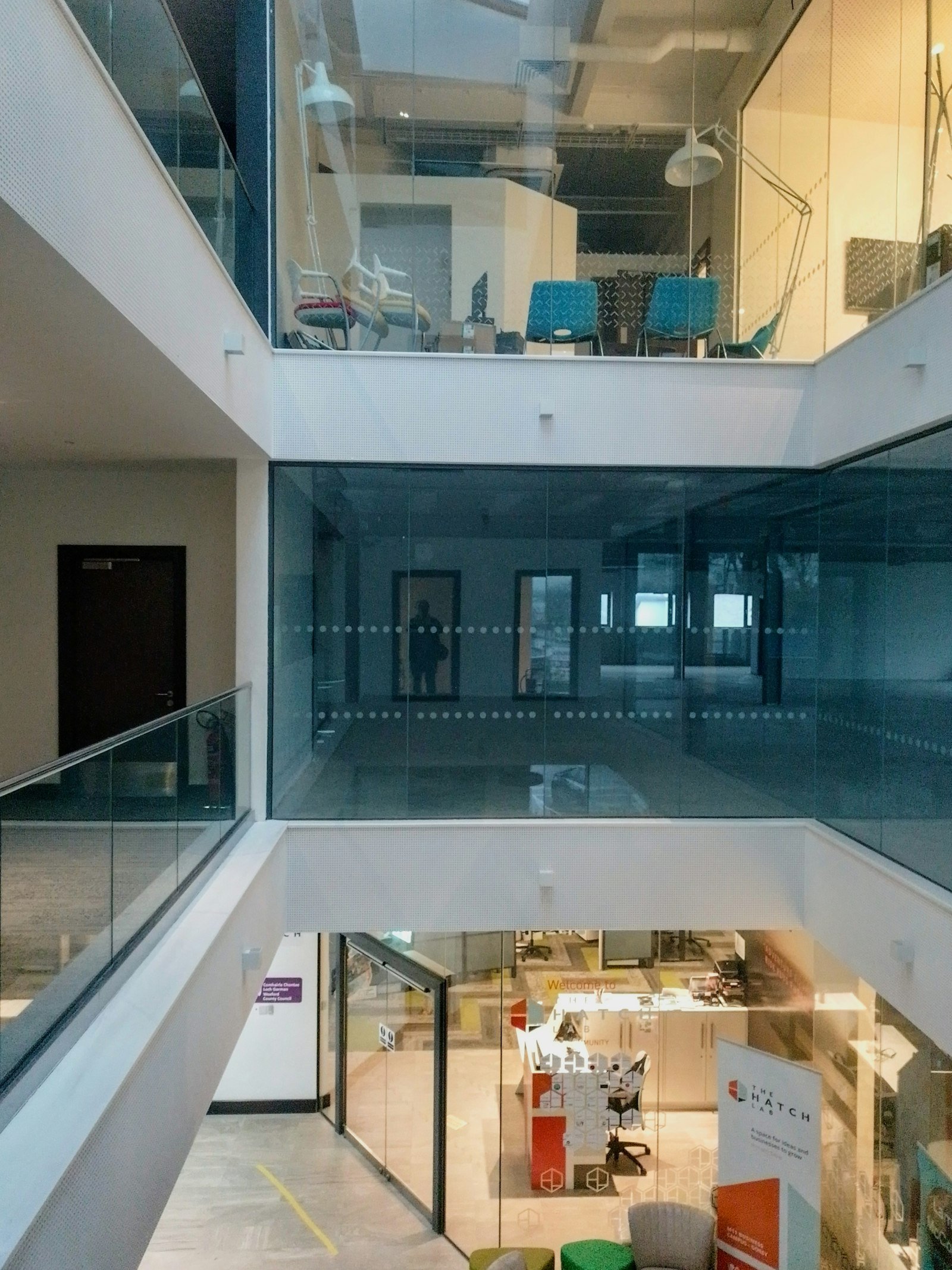Empty glass and steel staircase in a modern office building, representing the climb from a commercial leadership seat to the CEO role