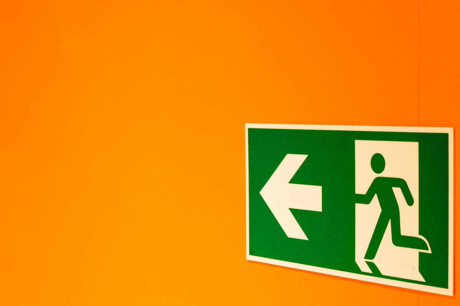 Illuminated emergency exit sign in a corridor