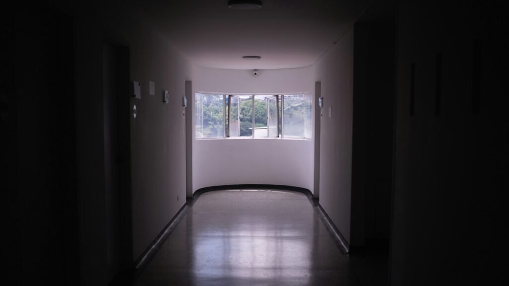 An empty hospital corridor lit at night