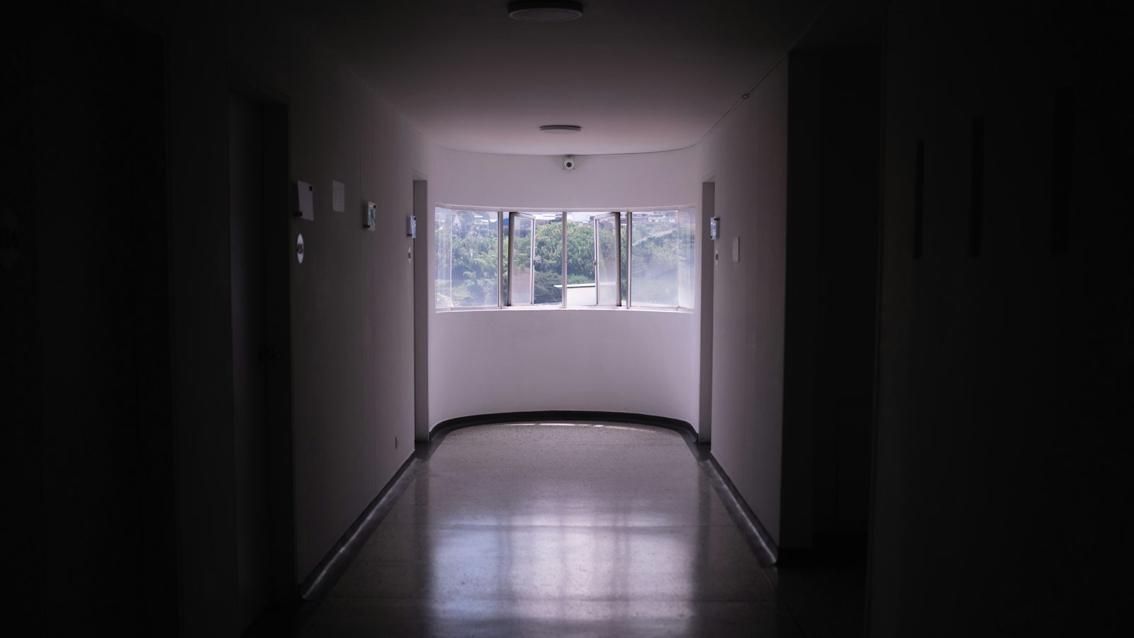 An empty hospital corridor lit at night
