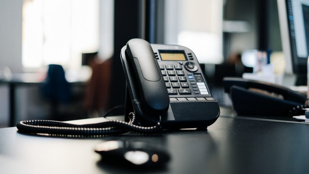 Empty clinic reception desk with a telephone and appointment book