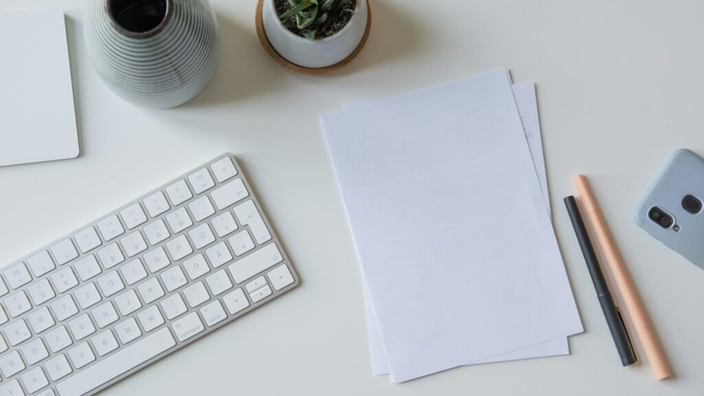Rubber stamp resting on a stack of printed documents on a desk