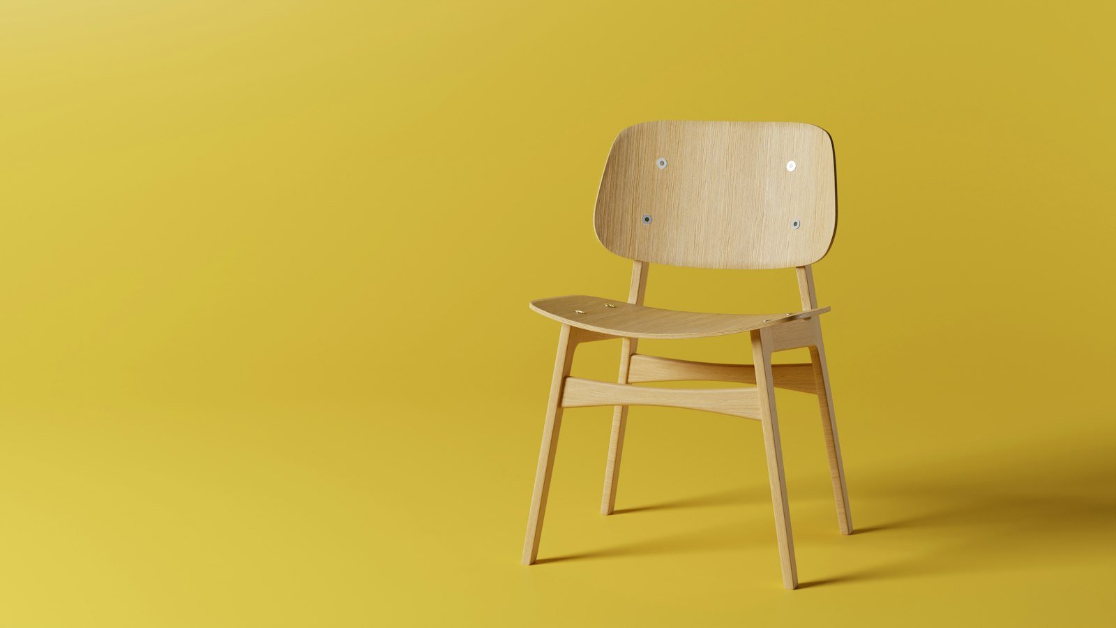 Two empty chairs facing each other across a small table in a bright room