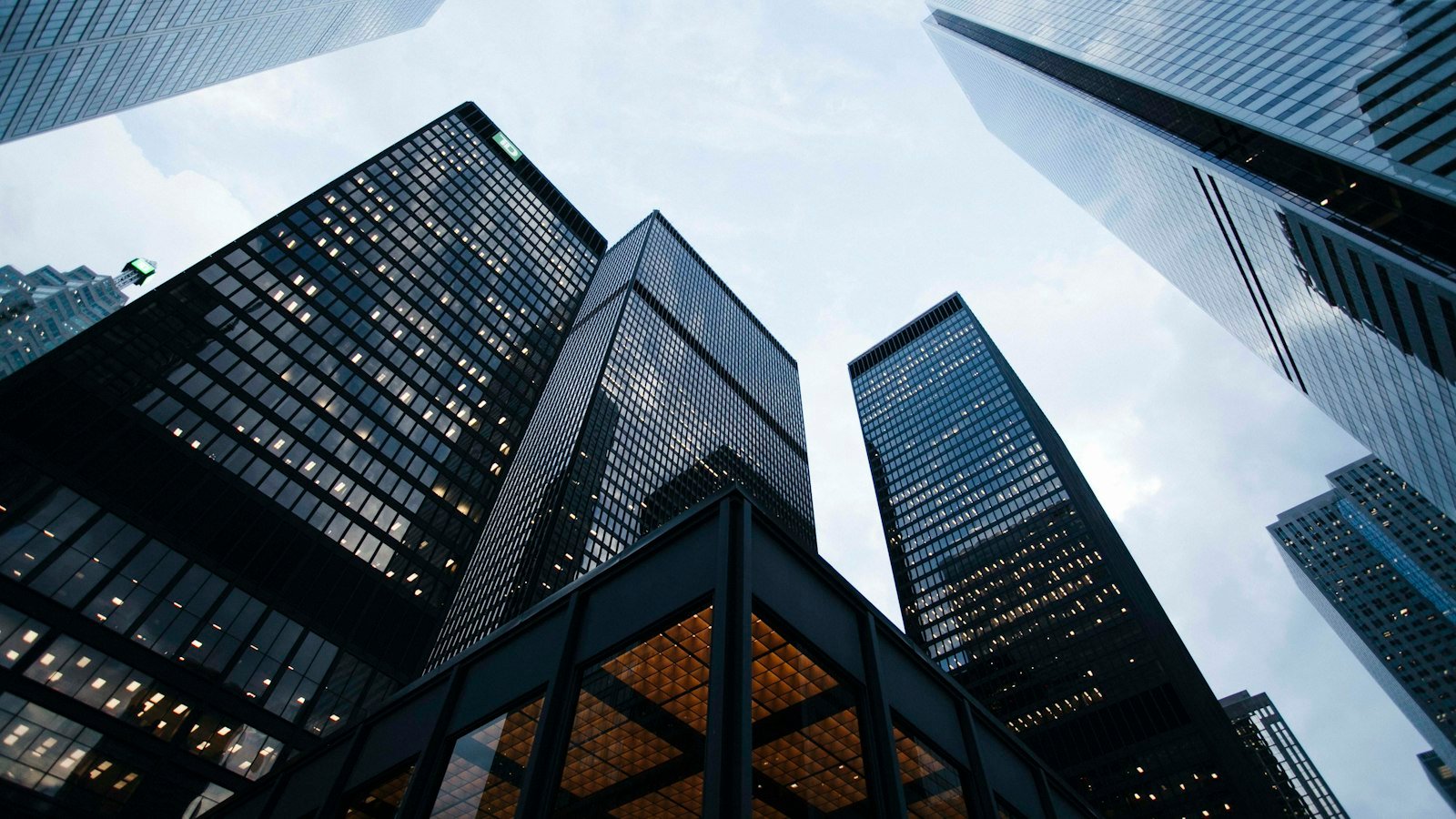 Tall glass office towers seen from below