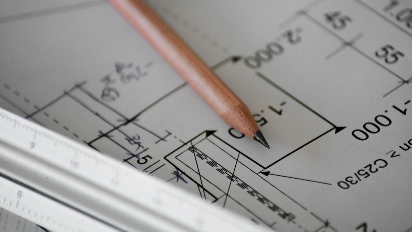 Architectural plans on a desk, representing an agency scope