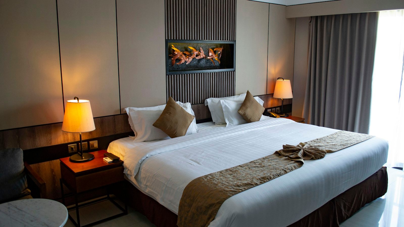 Crisp white bed linen and pillows in a hotel style room
