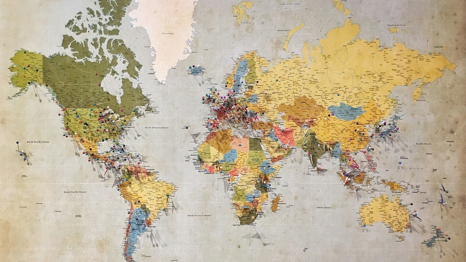 A colourful political world map printed on textured paper