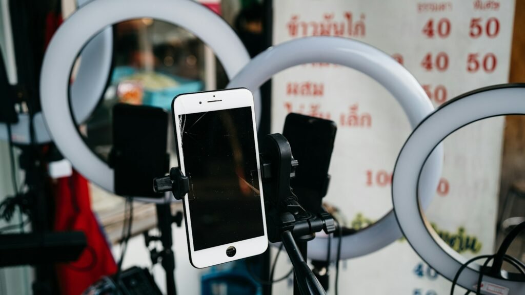 Smartphone mounted on a tripod beside a ring light