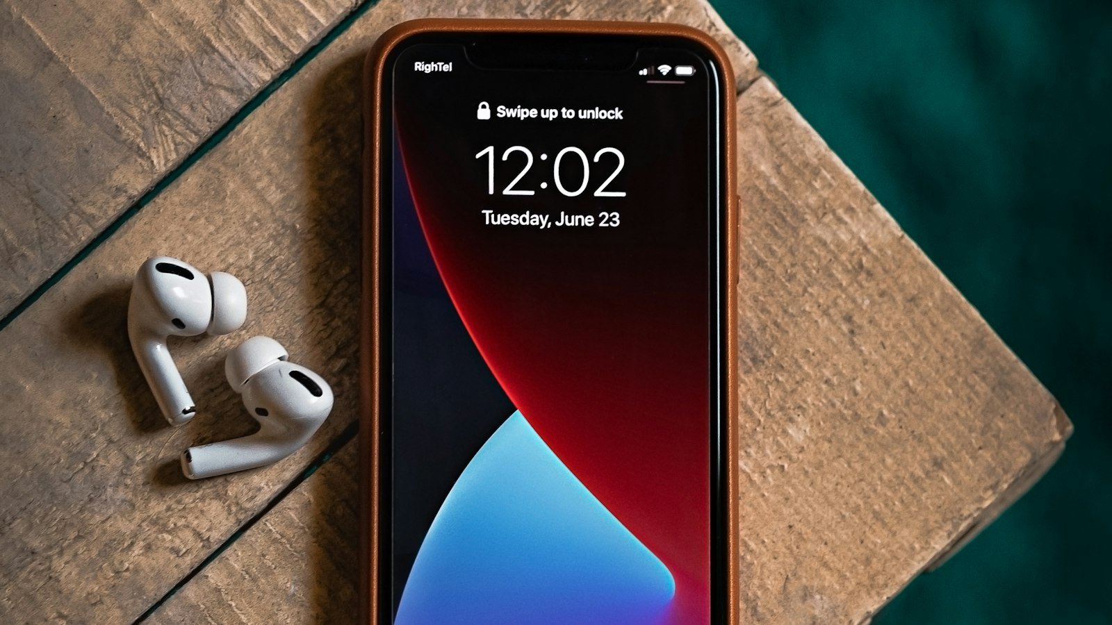 A red and black smartphone on a table