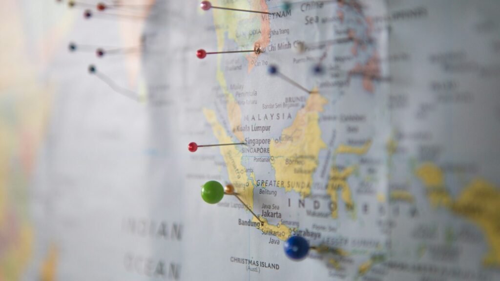 Paper city map with coloured pins marking locations