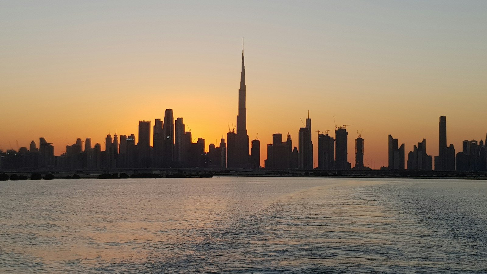 City skyline across the water at sunset