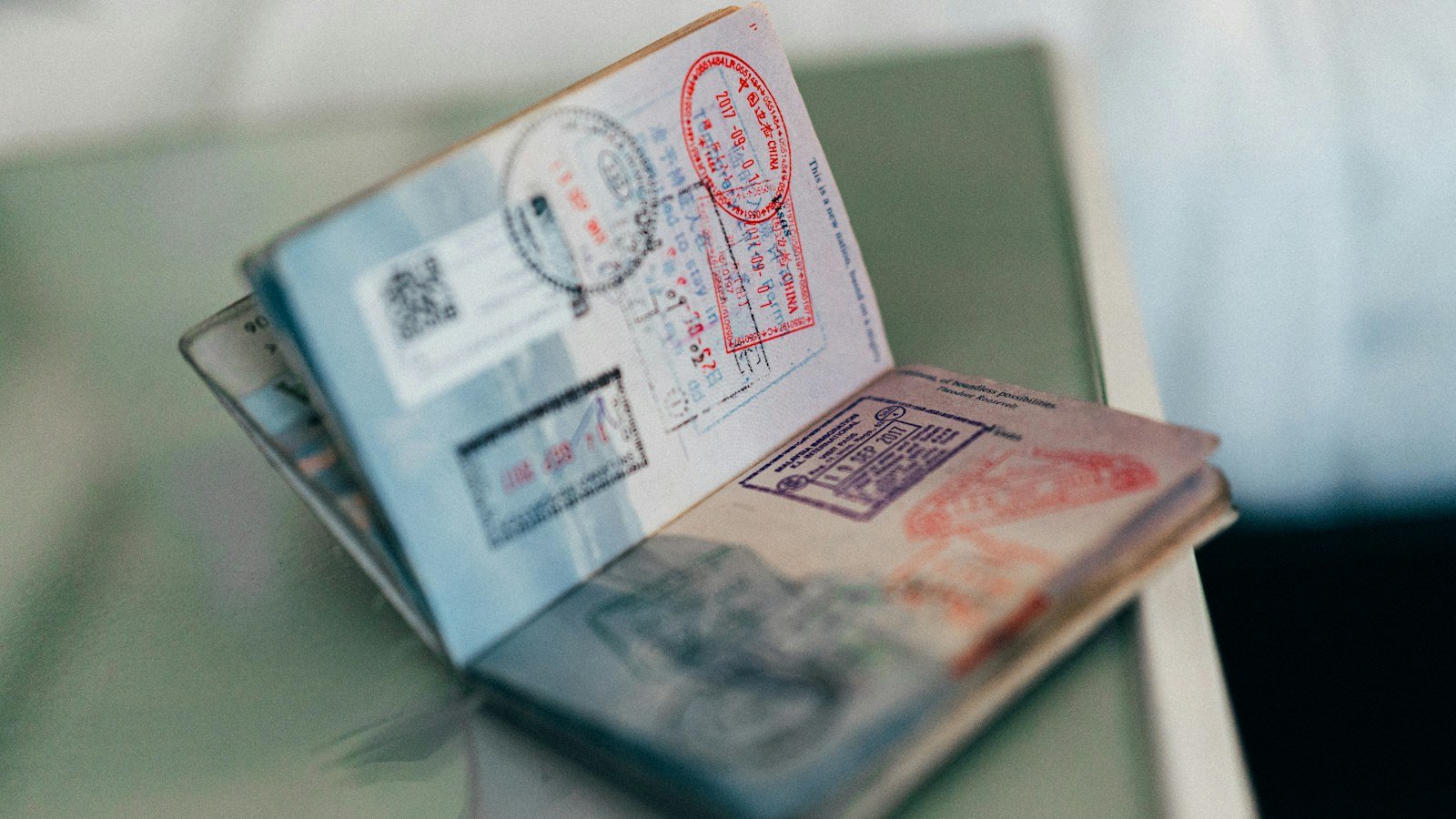 An open passport showing colourful entry and exit ink stamps