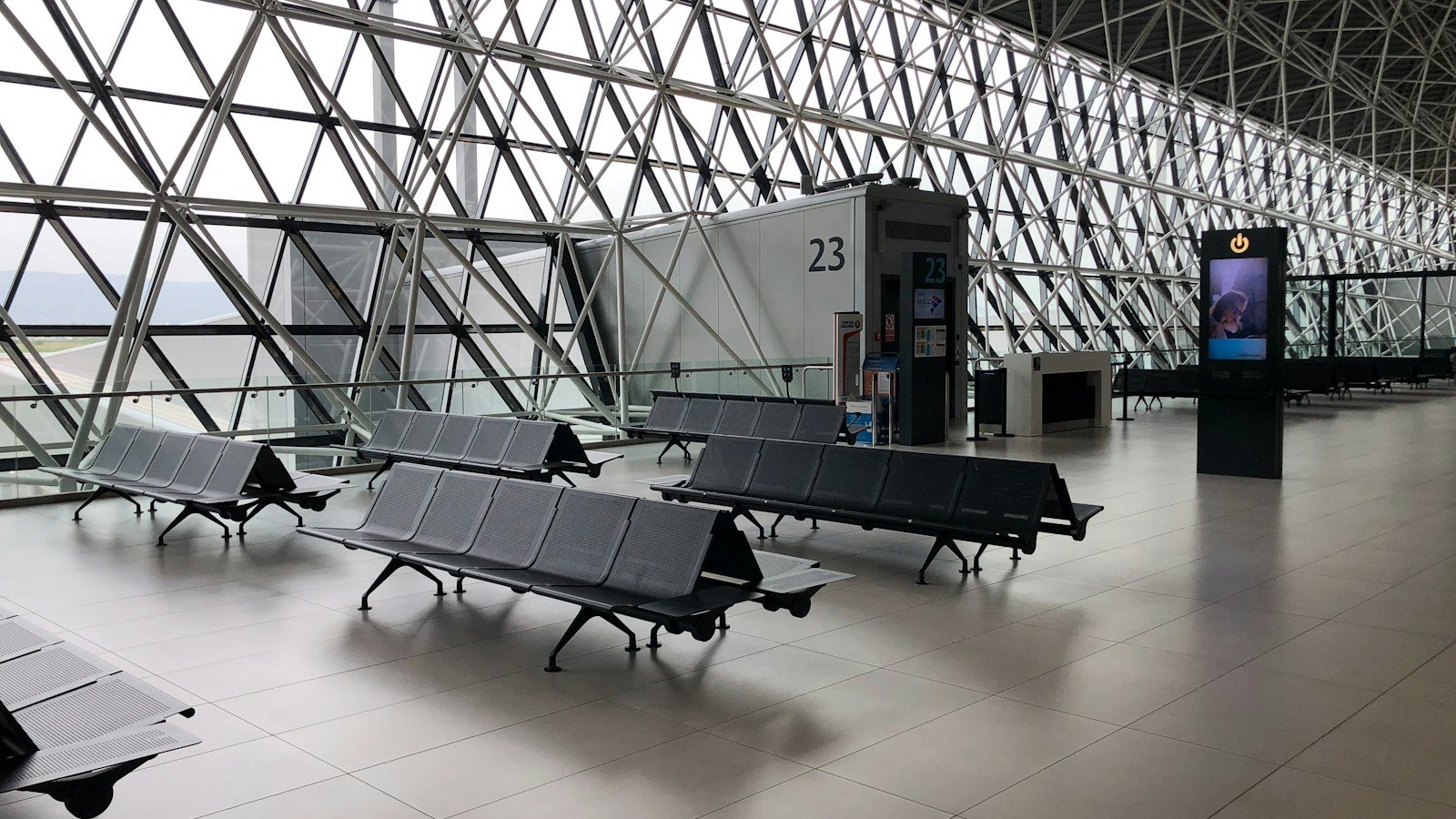 Empty rows of seats in a quiet airport departure hall