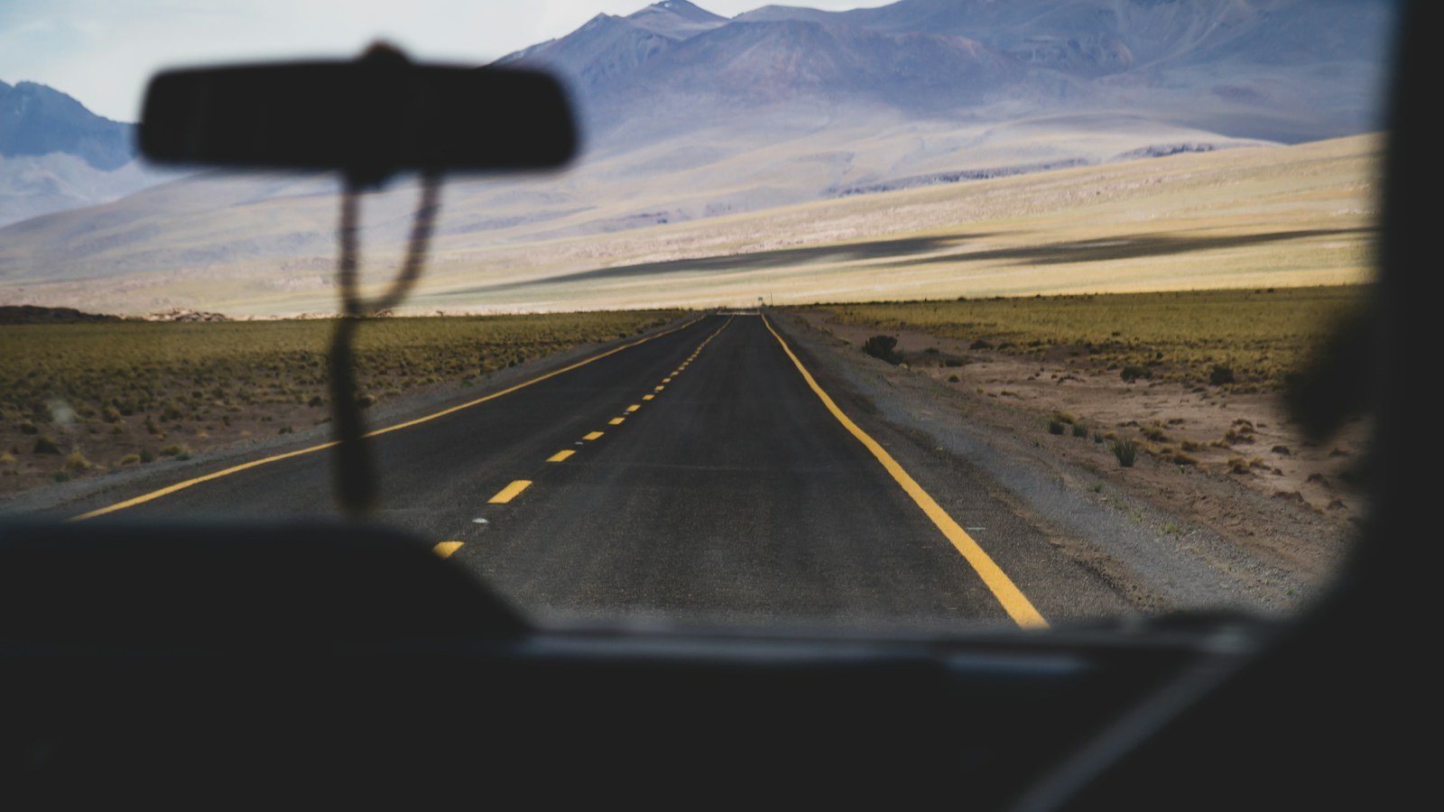 View through a car windscreen of an empty open highway