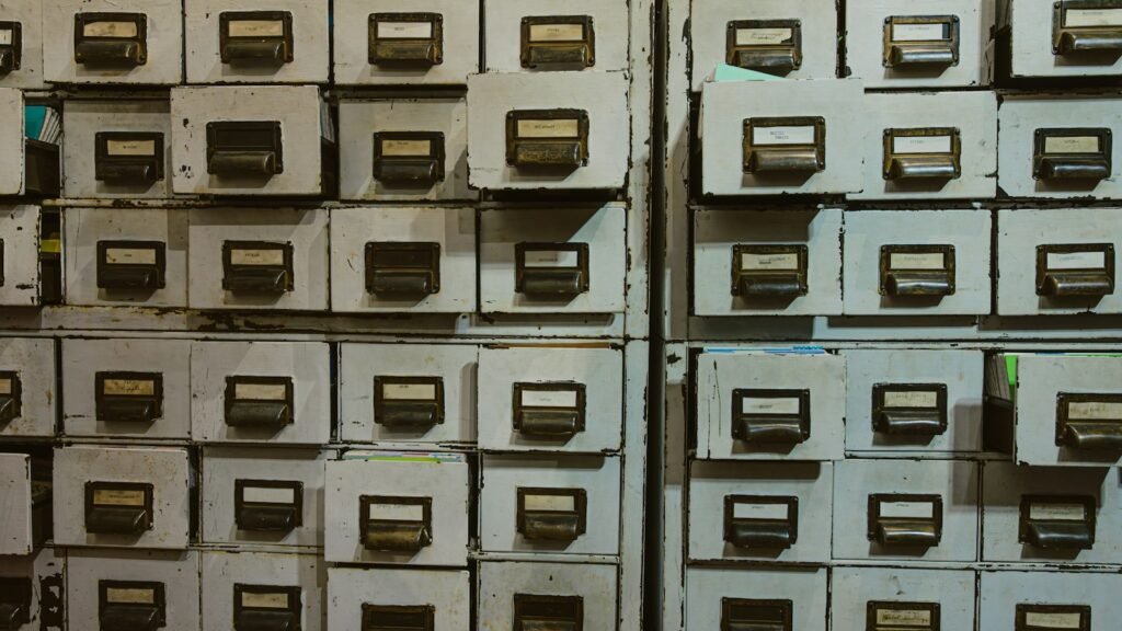 Row of labelled metal filing cabinet drawers