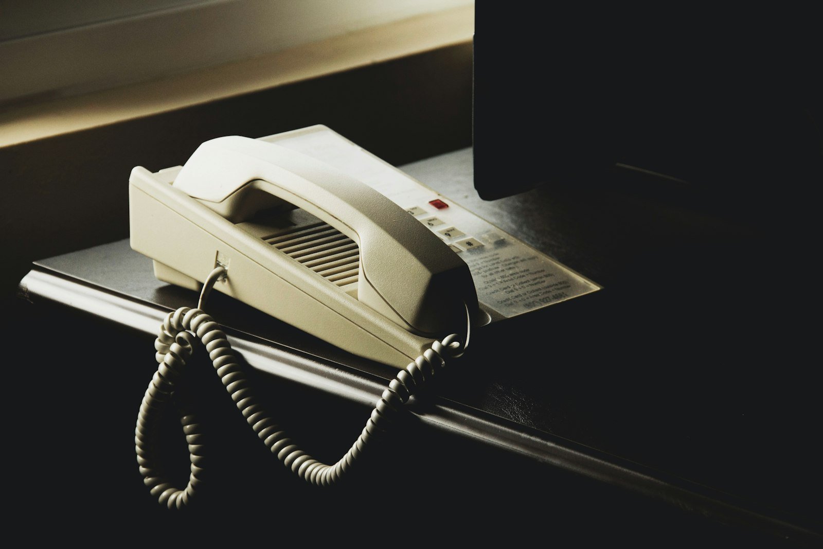 A telephone handset on an office desk