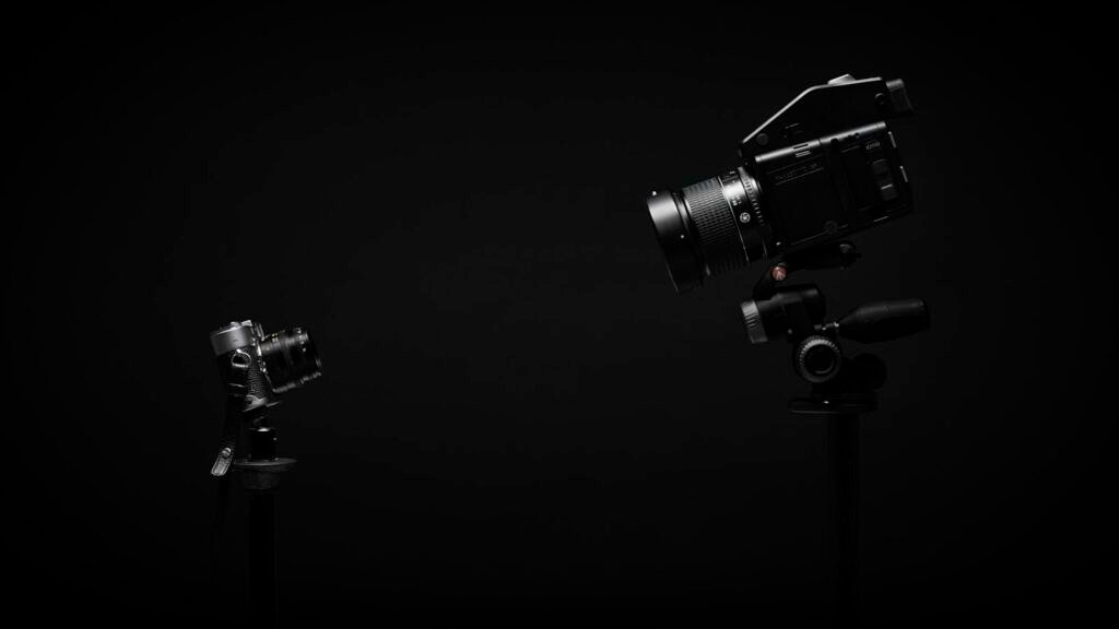 Camera, microphone and a softbox light arranged for a small video shoot
