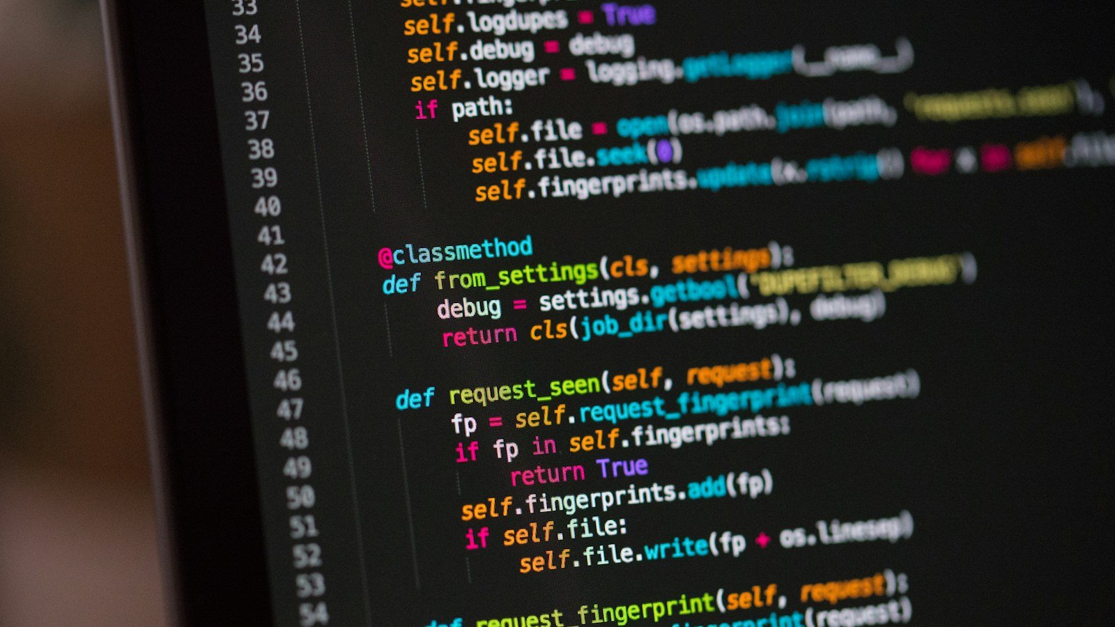 Colourful lines of programming code on a dark computer monitor