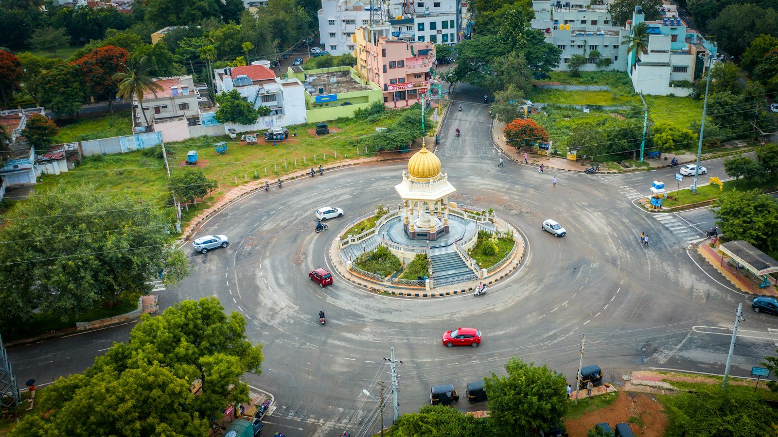 Aerial view of a busy roundabout and neighbourhood in an Indian city