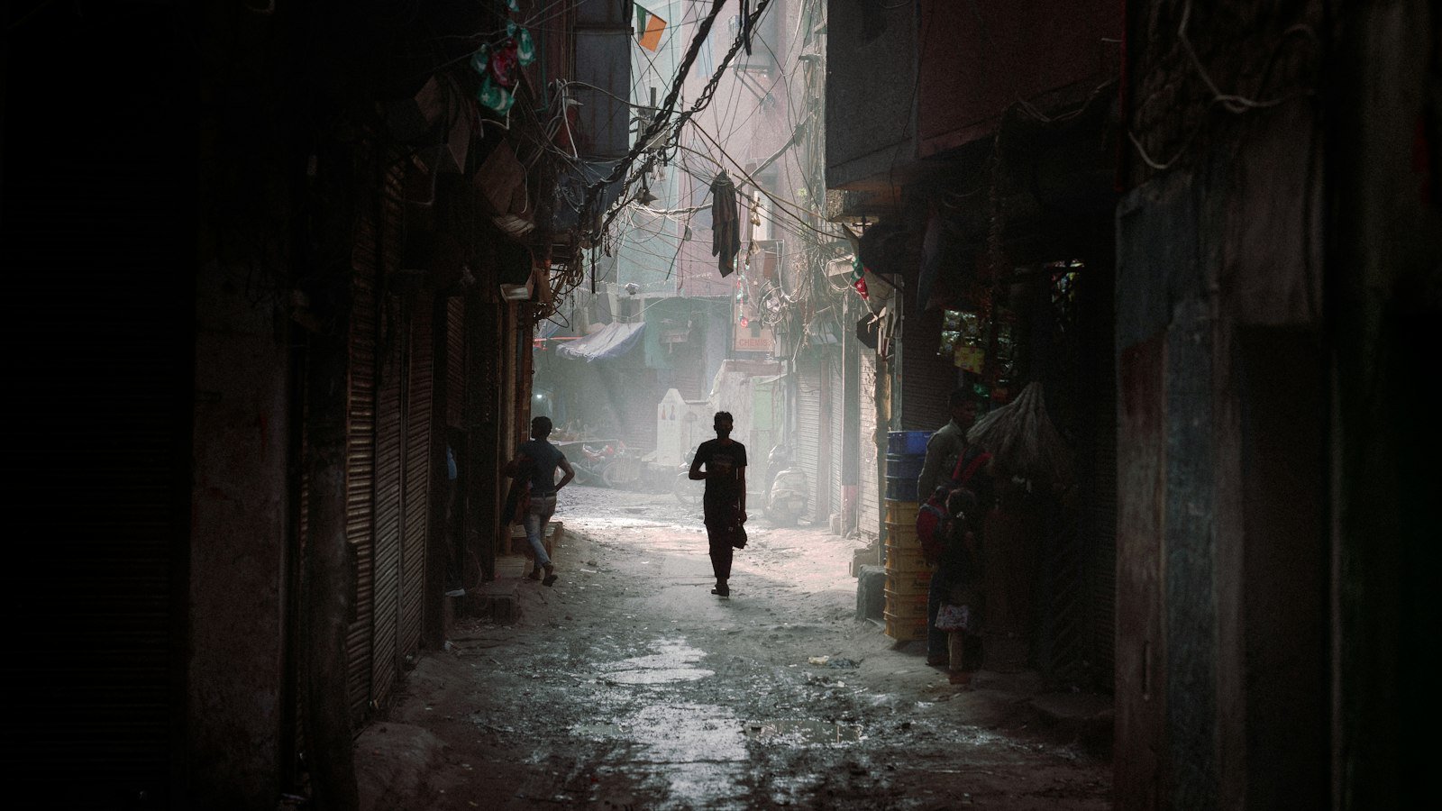 A narrow lane in an Indian town lined with old buildings