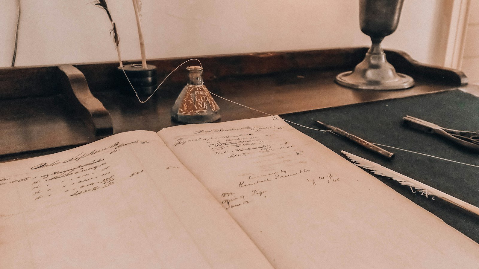 A stethoscope resting on an open reference book on a wooden desk