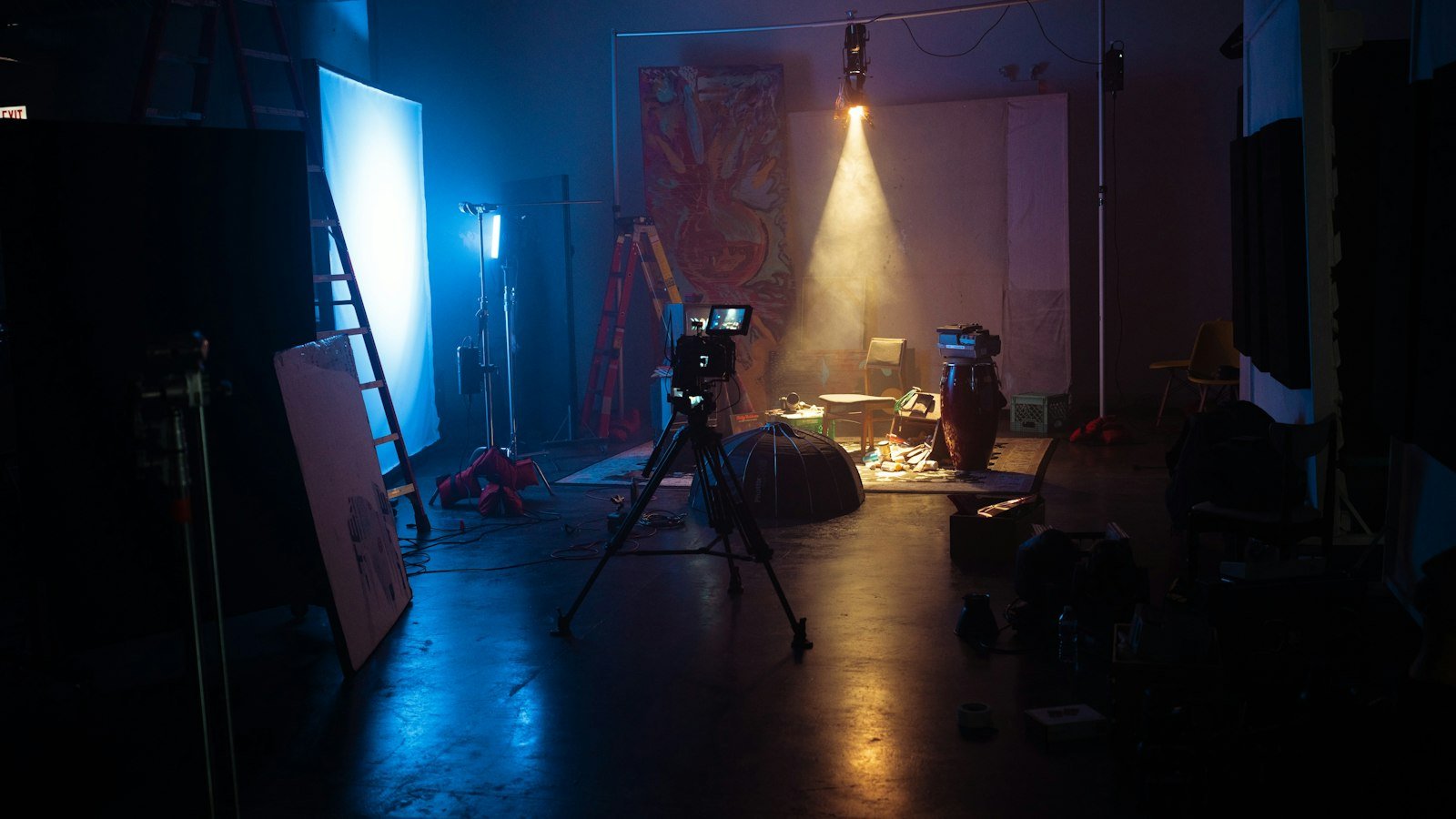Video camera on a tripod in a small studio with soft lights