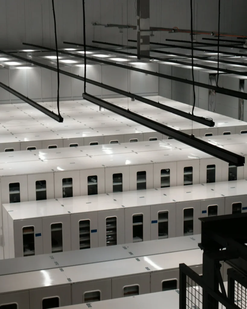 Rows of server cabinets in a modern data centre, representing the infrastructure behind a hospital group AI strategy