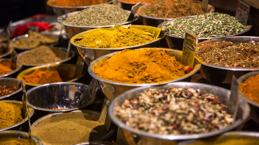 Steel bowls of herbs and spices on a table