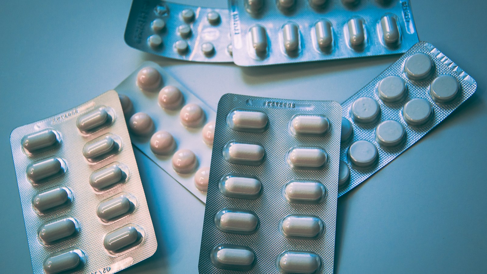 White and blue medication pills in a blister pack