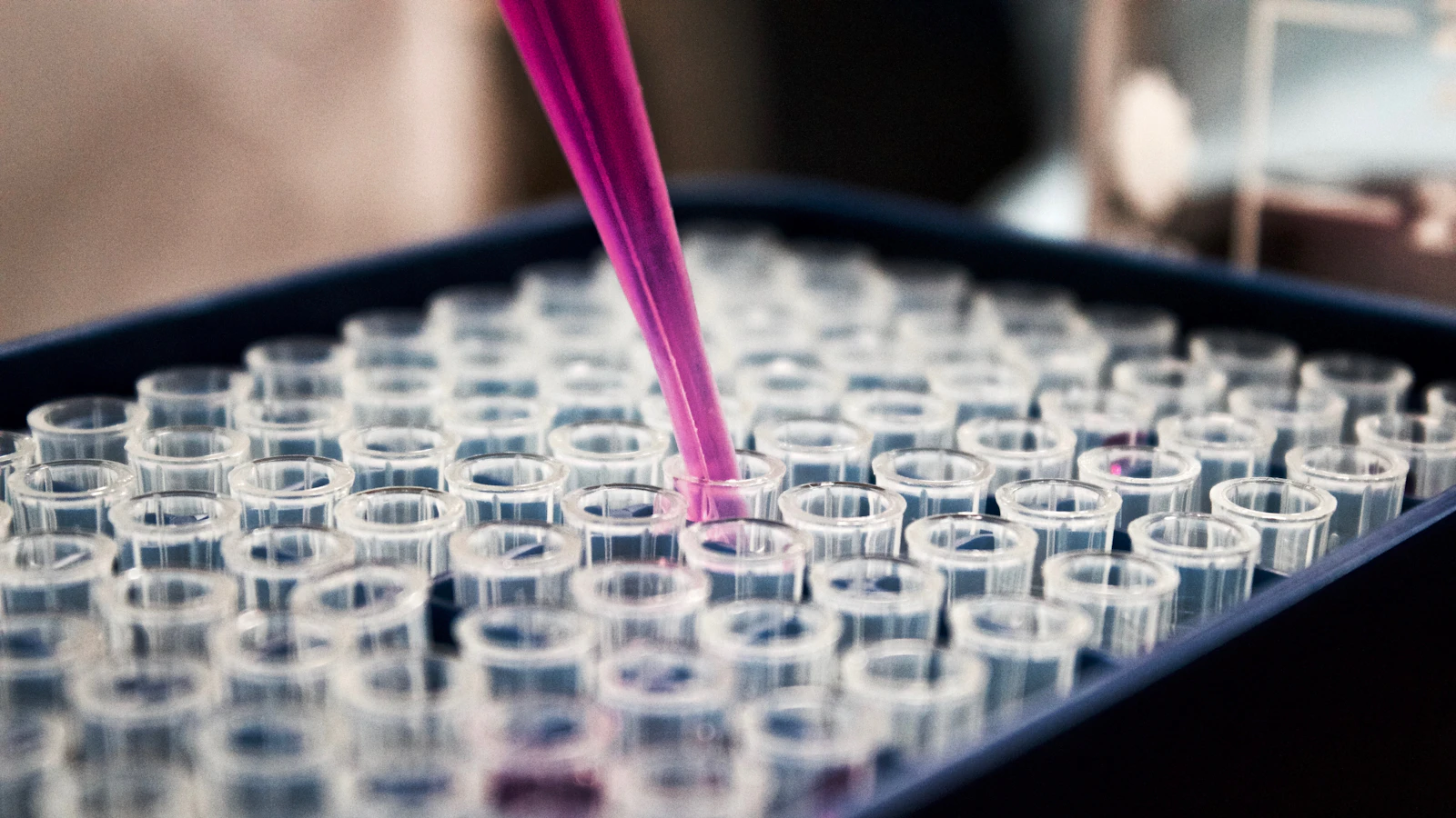 Laboratory test tubes being filled with liquid