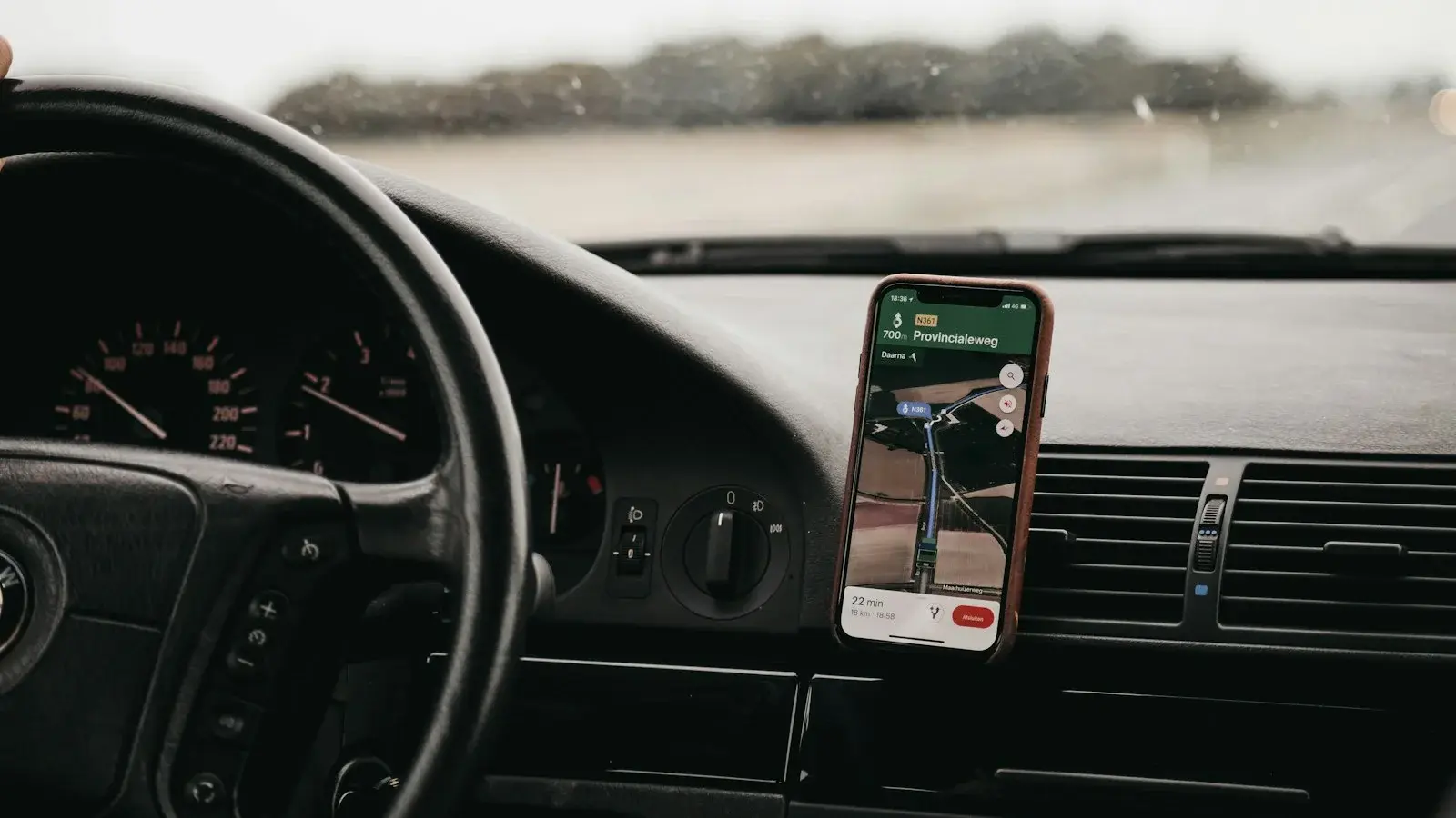 Smartphone showing a map, mounted in a car