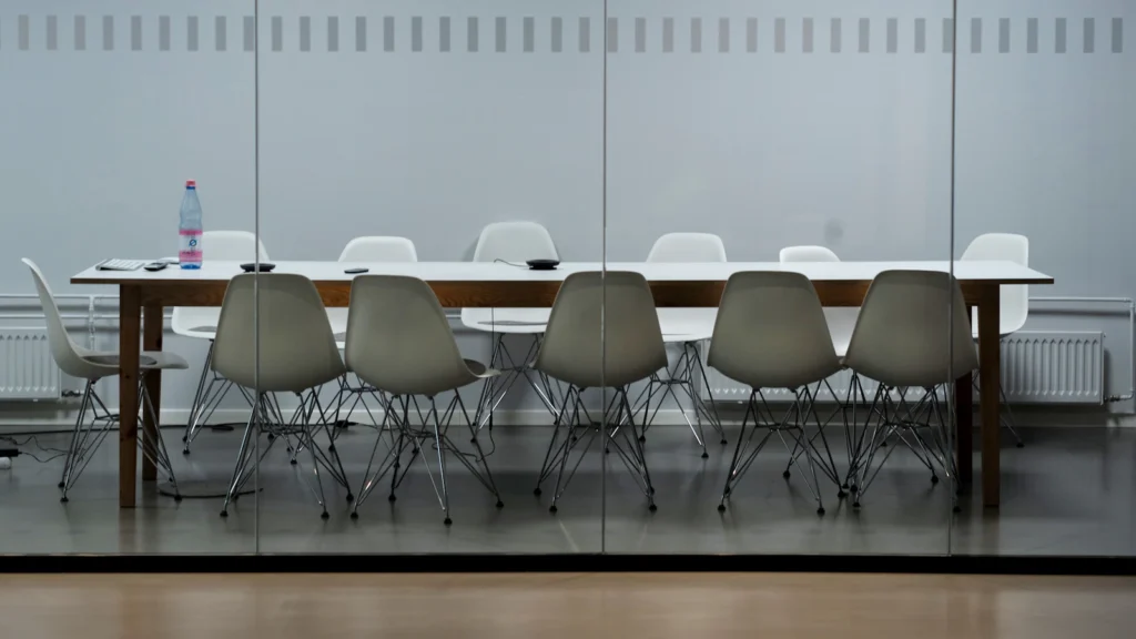 Long meeting table with chairs in an empty room