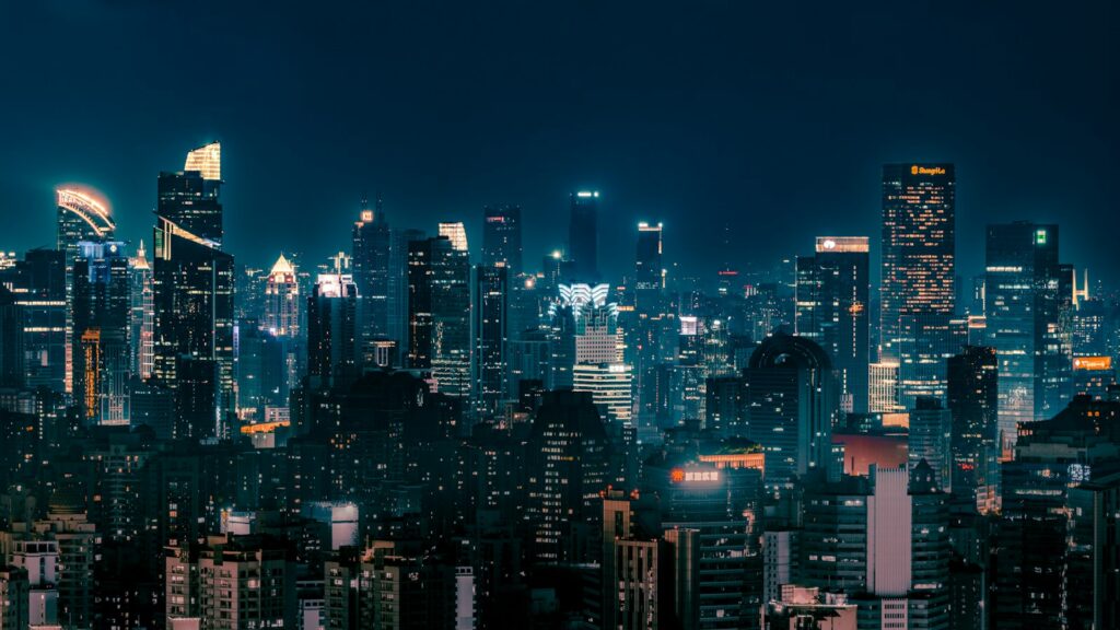 Skyscrapers illuminated at night across a city skyline
