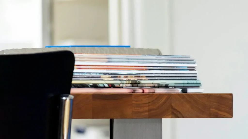 A stack of folded newspapers on a desk