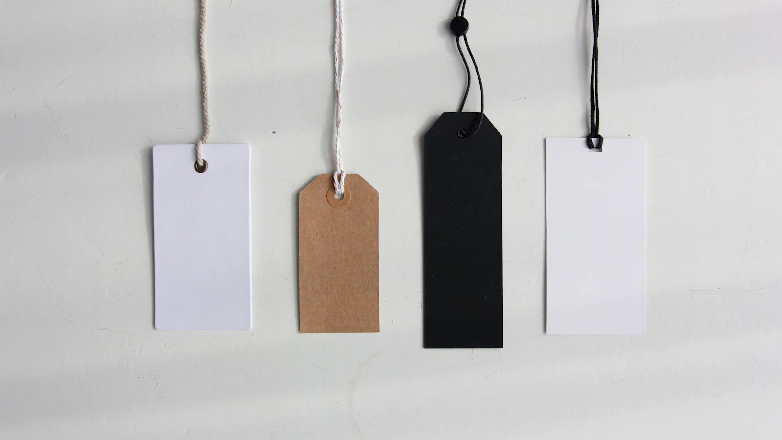 Four blank paper price tags