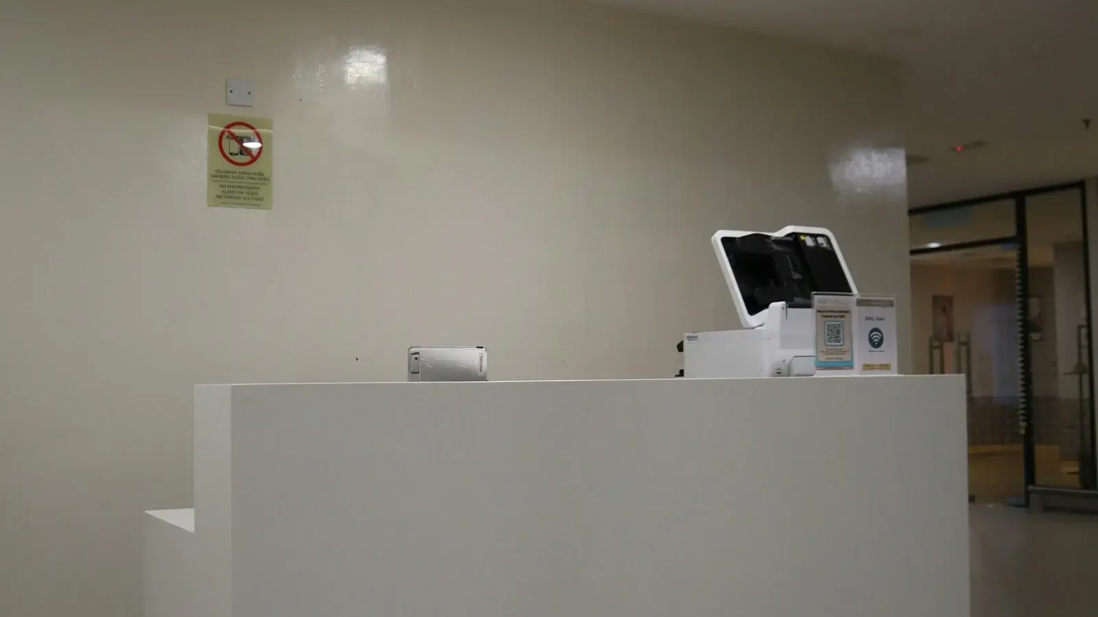 Modern reception desk with a sign overhead
