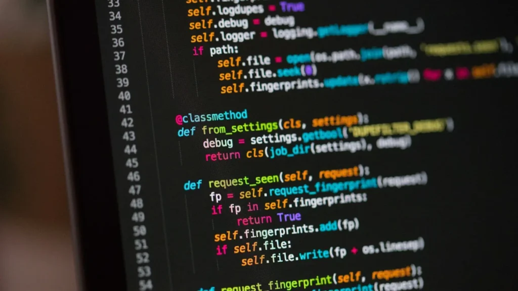 Colourful lines of programming code on a dark computer monitor