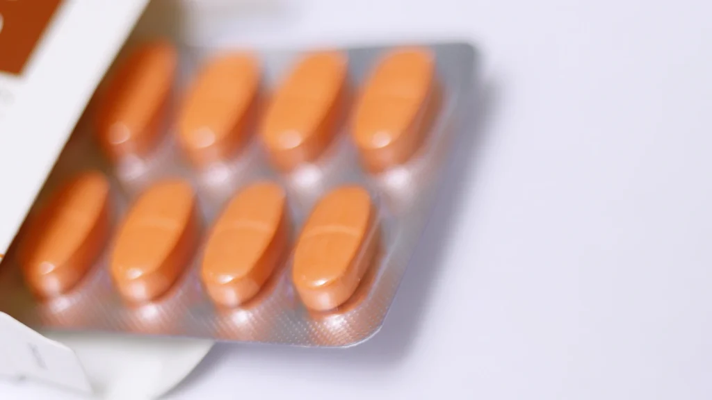 A strip of tablets on a white table